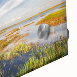 Close-up of a vibrant acrylic glass wall art piece depicting a serene marsh landscape, showcasing rich greens and blues, perfect for nature-themed decor.