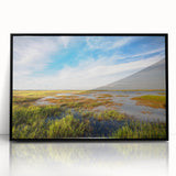 Framed acrylic wall art showcasing a serene marsh landscape with lush greenery and a tranquil swamp setting, featuring a sleek black frame for modern decor.