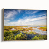 Framed canvas wall art showcasing a serene marsh landscape with vibrant greens and earthy tones, featuring a sleek gold frame, perfect for modern decor.