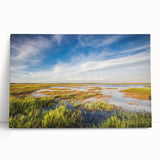 Stretched canvas wall art showcasing a serene landscape of a marsh and swamp, featuring vibrant greens and blues, perfect for nature lovers and home decor enthusiasts.