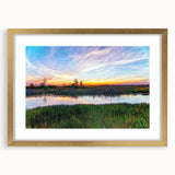 Framed wall art featuring a serene marsh landscape with lush greenery and gentle water reflections, elegantly bordered in gold, perfect for home decor.