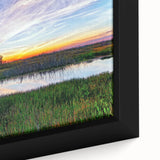 Close-up of a framed canvas wall art piece depicting a serene marsh landscape with vibrant greens and blues, ideal for nature lovers and home decor enthusiasts.