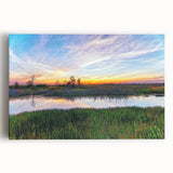 Stretched canvas wall art depicting a serene marsh landscape with lush greenery and tranquil water reflections, perfect for nature-themed decor in homes or offices.