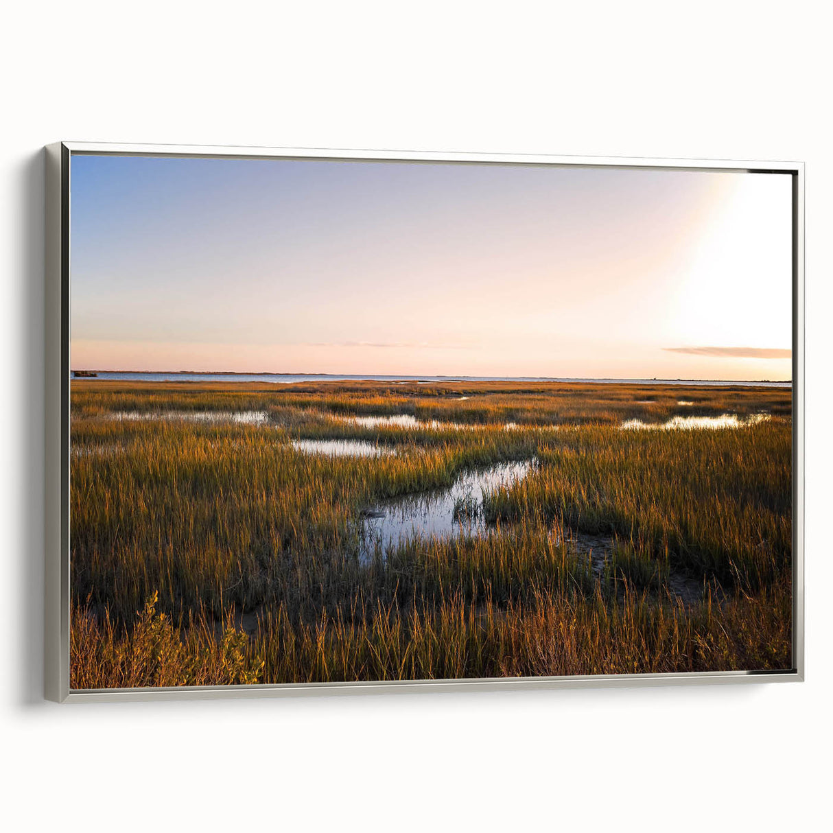 Framed canvas wall art showcasing a serene marsh landscape with lush greenery and reflective water, accented by a silver frame, ideal for home decor.