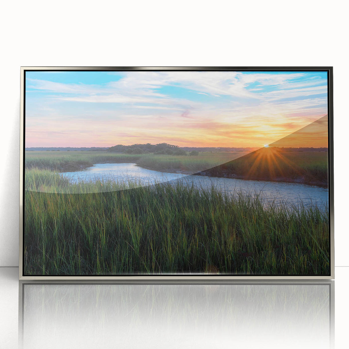 Framed wall art featuring a serene marsh landscape, showcasing vibrant green vegetation and a tranquil blue sky, perfect for nature-inspired home decor.