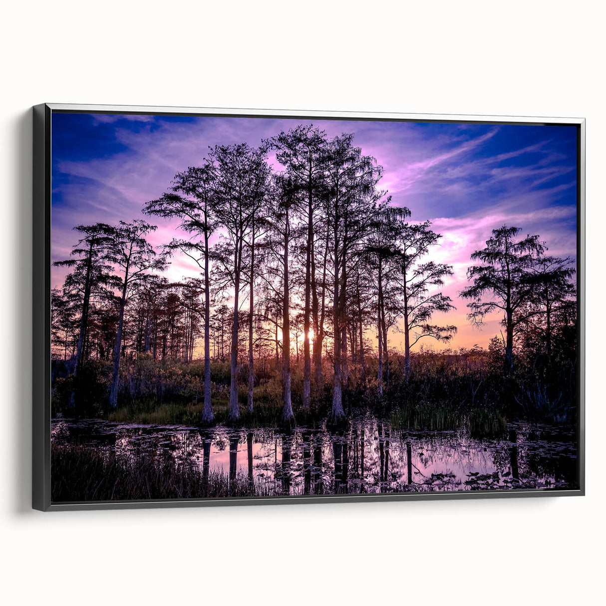 Framed wall art collection showcasing a serene marsh landscape with lush greenery and tranquil water reflections, presented in a sleek black frame for an elegant finish.