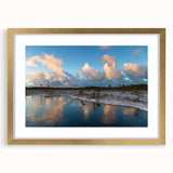 Framed wall art featuring a serene marsh landscape scene, showcasing lush greenery and tranquil water reflections, accented with a gold mat for an elegant touch.