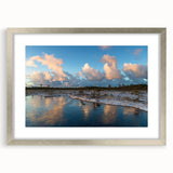 Framed wall art showcasing a serene marsh landscape in soft greens and blues, featuring a silver mat and frame, perfect for enhancing home decor with nature-inspired aesthetics.