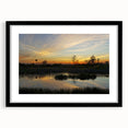 Framed wall art collection featuring a serene marsh landscape with lush greenery and reflective water, set in a sleek black frame with a white mat, perfect for enhancing home decor.