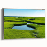 Framed canvas wall art depicting a serene marsh landscape with lush greenery and tranquil water, accented by a sleek silver frame, ideal for nature-themed decor.