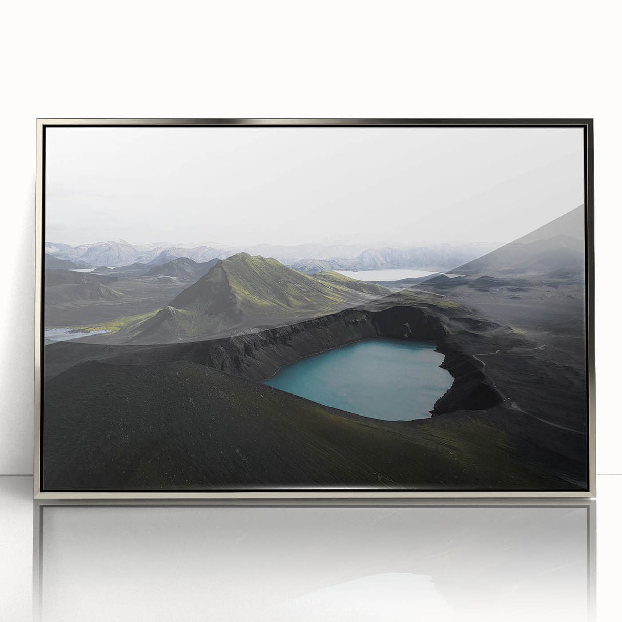 Framed acrylic wall art showcasing a misty landscape design with soft fog tones. The piece features a sleek silver frame, enhancing its modern aesthetic, perfect for home decor.