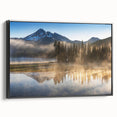 Framed canvas wall art showcasing a serene foggy landscape with muted colors and intricate details, viewed from the side to highlight its black frame.