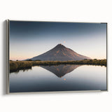 Framed canvas wall art depicting serene mountain landscapes in soft blue and gray tones, showcased with a sleek silver frame, perfect for home décor.