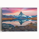 Stretched canvas wall art showcasing a stunning landscape of majestic mountains under a vibrant sunset, perfect for adding a serene touch to any space.