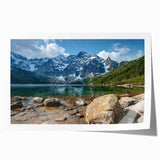 Vibrant rolled print of a mountain landscape, showcasing majestic peaks under a clear blue sky, ideal for modern home decor and nature-inspired interiors.