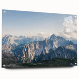 Acrylic glass wall art showcasing a vibrant mountain landscape design with rich colors and intricate details, elegantly displayed at an angle with visible mounting pins. Ideal for enhancing contemporary home decor with nature-inspired aesthetics.