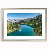 Framed landscape wall art showcasing majestic mountains with a silver mat, perfect for home decor. This elegant piece adds a touch of nature-inspired beauty to any room.