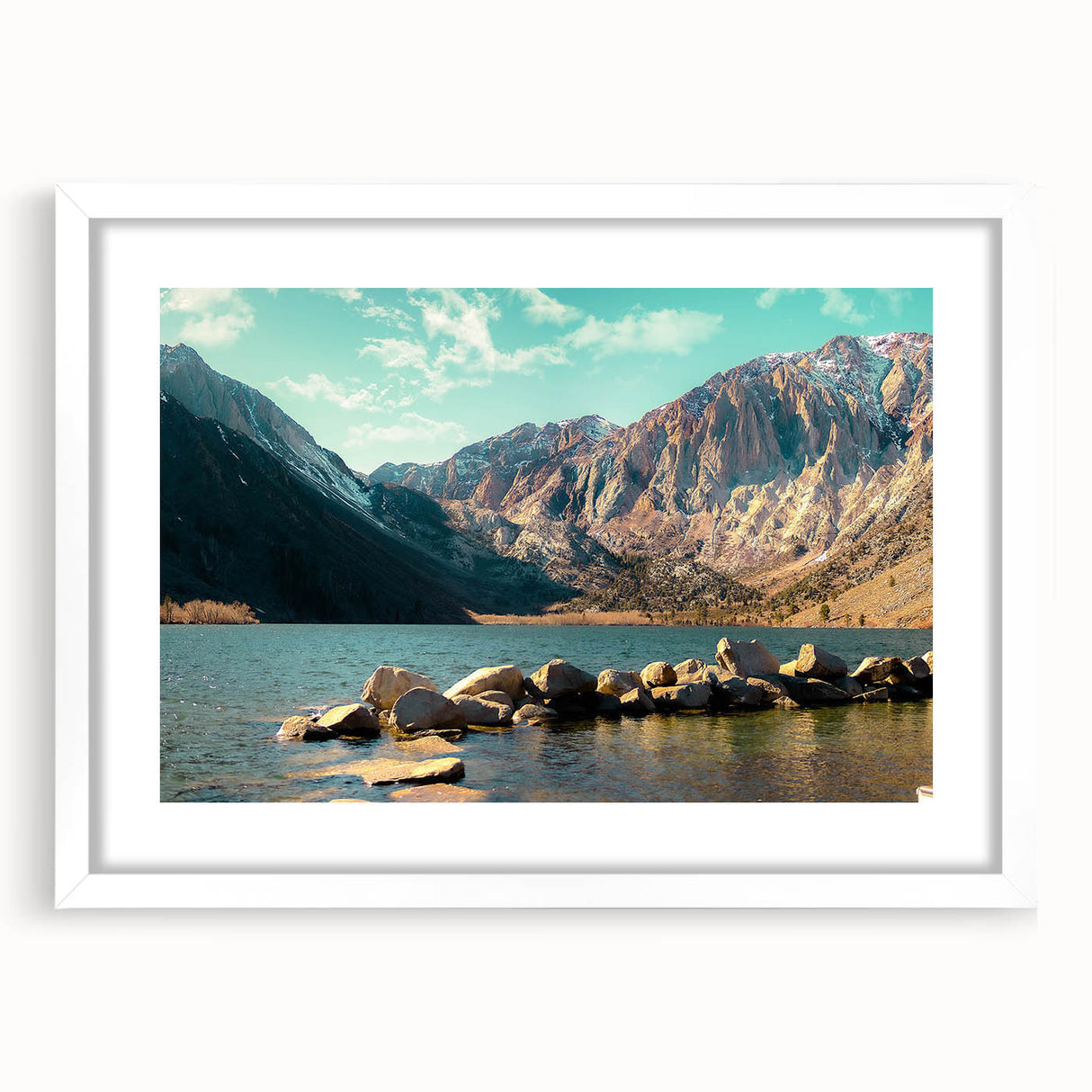 Framed landscape wall art featuring majestic mountains, set in a sleek white mat and frame, ideal for home decor and enhancing interior aesthetics.