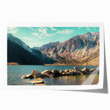 Vibrant rolled print of a mountainous landscape, showcasing rich colors and intricate details, ideal for home decor or art collection, packaged securely in a tube.