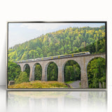 Framed wall art featuring a scenic landscape with railroad tracks, accented with a silver frame, perfect for home decor, showcasing vibrant colors and intricate details.