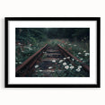 Framed black wall art featuring a captivating landscape design with railroad elements, presented in a sleek black frame with a white mat, perfect for modern decor.