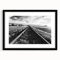 Framed wall art featuring a scenic railroad landscape design with a black matte frame, perfect for home decor, enhancing living spaces with a touch of nature.