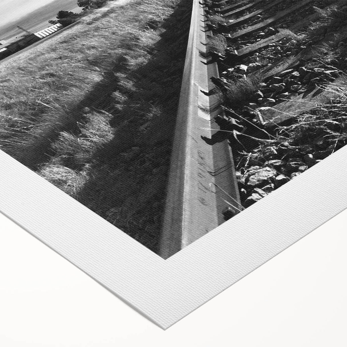 Rolled canvas showcasing a vibrant landscape design with railroad tracks, featuring rich colors and intricate details, ideal for enhancing home decor.