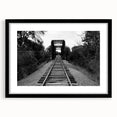 Framed wall art featuring a stunning landscape of railroads, presented in a sleek black frame with a mat. Perfect for enhancing home decor and showcasing artistic design.