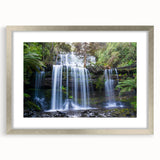 Framed wall art showcasing a vibrant rainforest landscape design with lush greenery and colorful flora, featuring a sleek silver frame and matting, perfect for home decor.