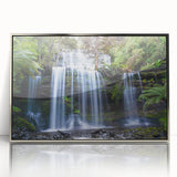 Framed acrylic wall art showcasing a vibrant rainforest landscape, featuring lush green foliage and a silver frame, ideal for enhancing modern home decor.