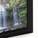 Close-up of a framed canvas depicting a vibrant rainforest landscape with lush greenery and a serene atmosphere, ideal for nature-themed decor or wall art collection.