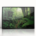Framed acrylic wall art featuring a vibrant rainforest landscape design with lush greenery and colorful flora, presented in a sleek black frame for modern decor.
