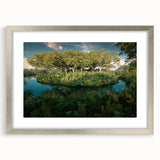 Framed rainforest landscape wall art collection featuring vibrant greens and intricate details, displayed in a sleek silver frame with a mat for an elegant finish.