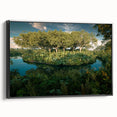 Framed canvas wall art showcasing a vibrant rainforest landscape design, displayed in a sleek black frame, perfect for enhancing modern home decor.