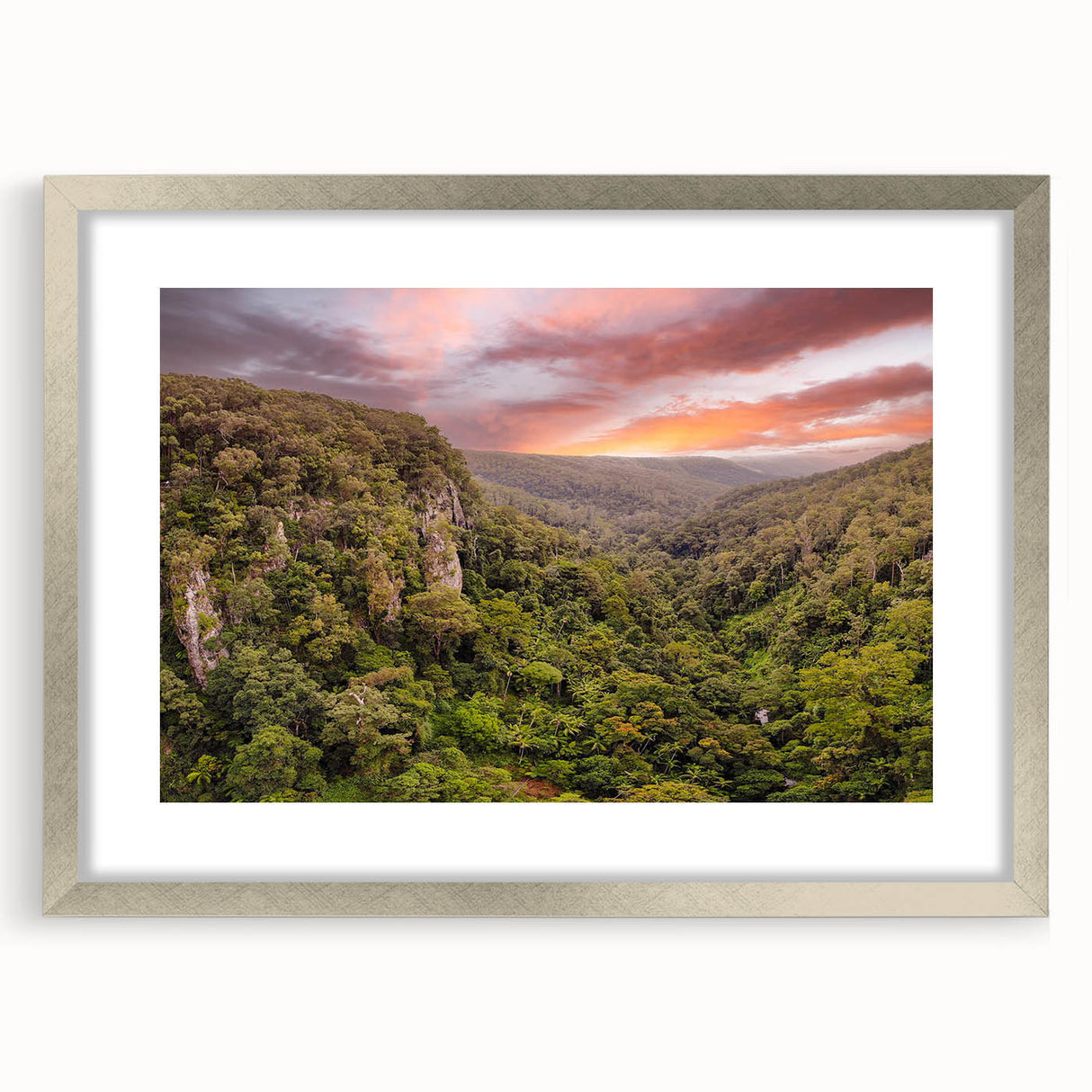 Framed wall art collection showcasing a vibrant rainforest landscape design, featuring rich greens and blues, elegantly presented with a silver mat and frame.