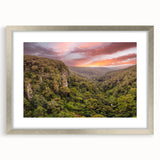 Framed wall art collection showcasing a vibrant rainforest landscape design, featuring rich greens and blues, elegantly presented with a silver mat and frame.