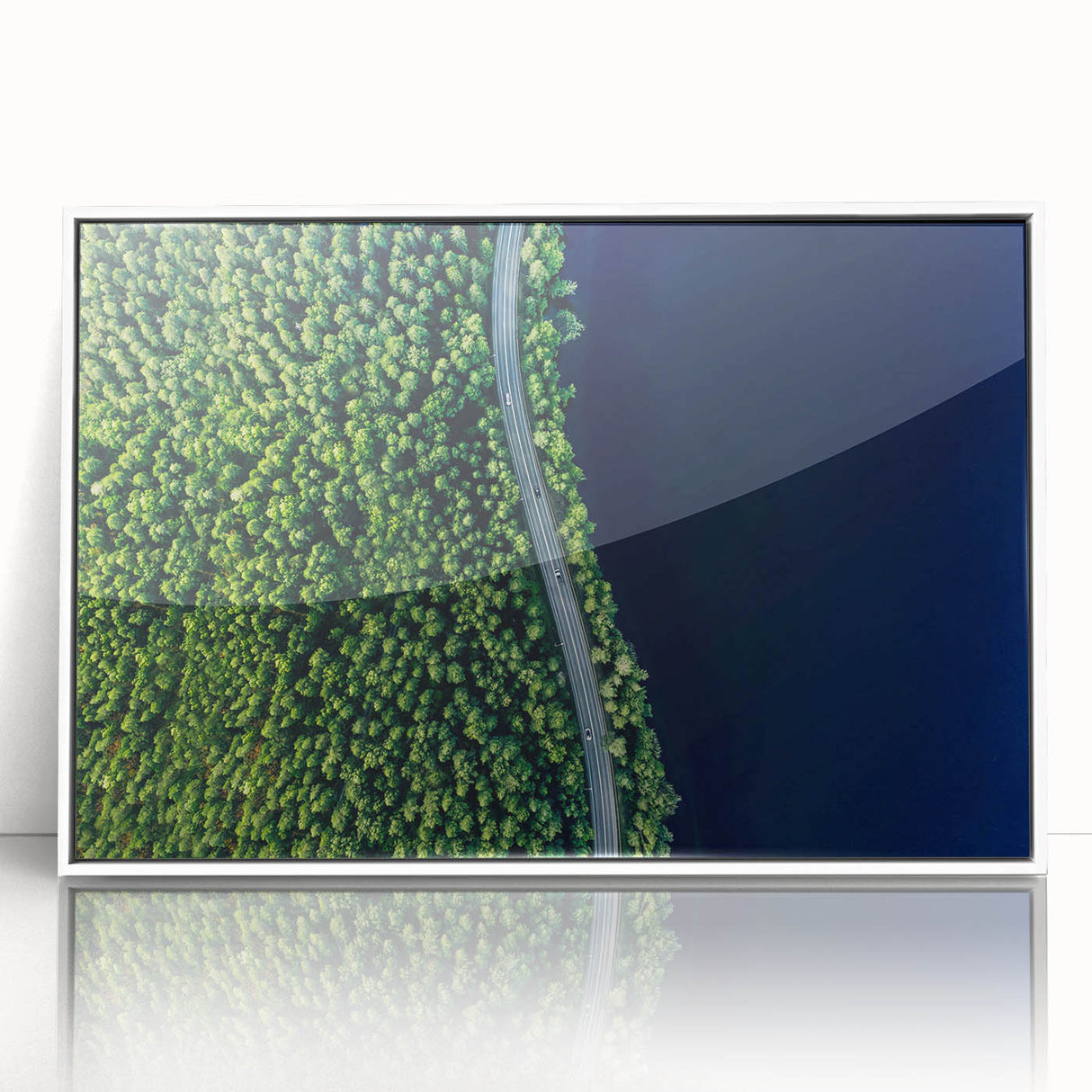 Framed acrylic wall art showcasing a serene landscape with winding roads, set against a white backdrop to enhance its vibrant colors and details. Perfect for home decor.