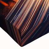 Close-up of a stretched canvas artwork depicting a vibrant landscape with winding roads, showcasing rich colors and intricate details, ideal for home decor enhancement.