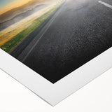 Vibrant rolled canvas artwork showcasing a scenic landscape with winding roads and lush greenery, perfect for home decor and aesthetic enhancement.