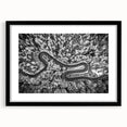 Framed landscape wall art showcasing a serene road scene, featuring a black frame and mat. Ideal for home decor, this piece enhances any living space with its calming aesthetic. Perfect for art enthusiasts seeking tranquility in their interior design.