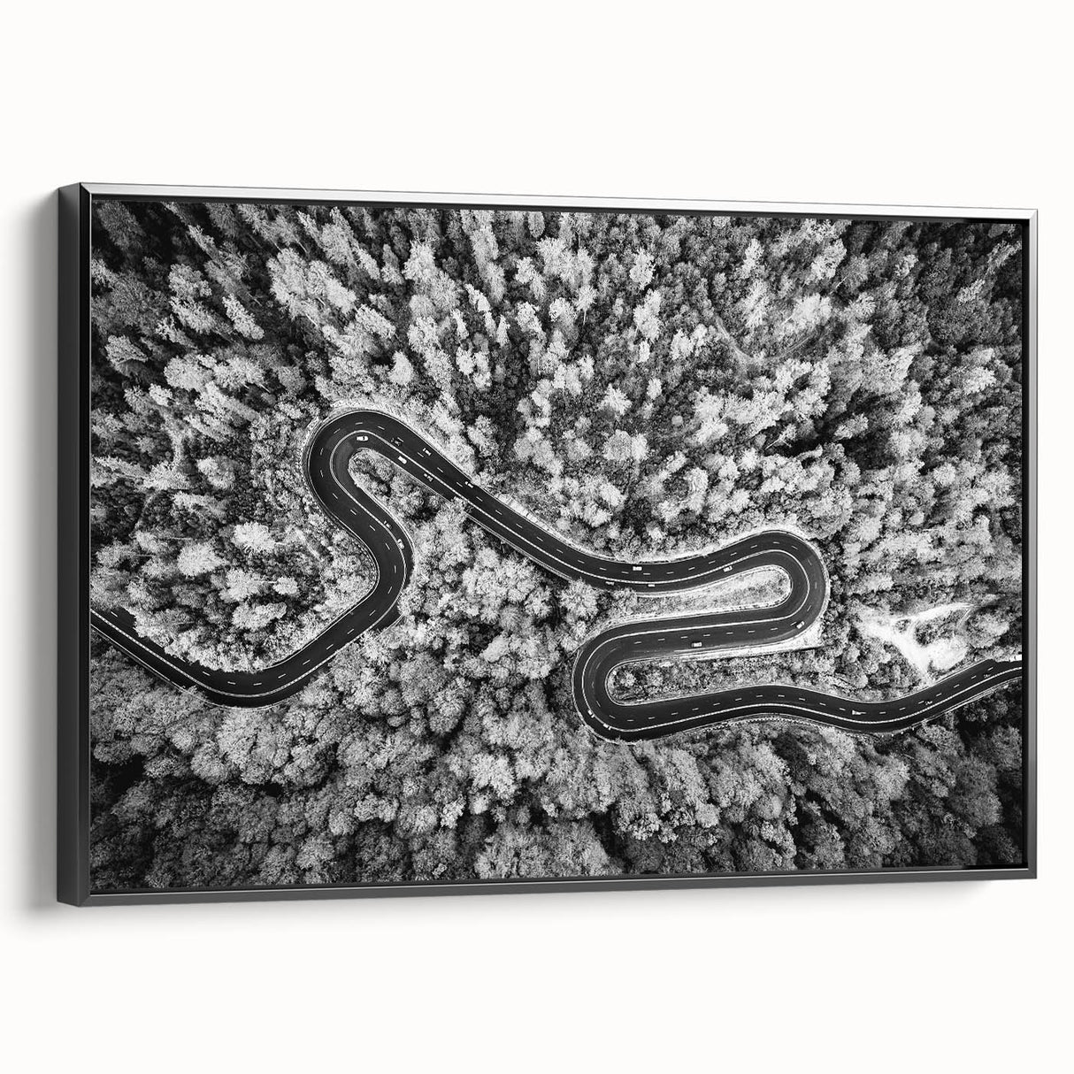 Framed canvas wall art showcasing a scenic landscape with winding roads, featuring a black frame and side view, ideal for modern home décor.