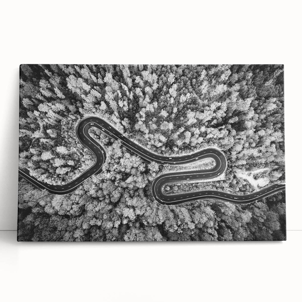 Stretched canvas artwork showcasing a vibrant landscape and road design, perfect for home decor. The colorful piece leans against a neutral wall, enhancing any interior setting.