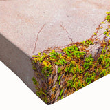 Close-up of a stretched canvas wall art featuring an abstract landscape design with vibrant colors and intricate rock formations, perfect for modern home decor.