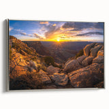 Framed canvas wall art featuring a serene landscape with textured rocks and soft earth tones, elegantly displayed with a silver frame, ideal for modern decor.
