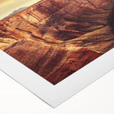 Rolled canvas artwork showcasing a vibrant landscape of rugged rocks and blue skies, ideal for home decor, presented in a protective cardboard tube.
