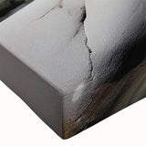 Close-up of a stretched canvas artwork showcasing a vibrant landscape with rocky formations and earthy tones, perfect for modern home decor.