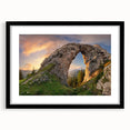 Framed wall art featuring a striking landscape design with rocks, presented in a sleek black frame and white mat, enhancing modern decor aesthetics.
