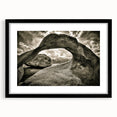Framed wall art depicting an abstract landscape with rocks, featuring a sleek black frame and white matting, perfect for modern home decor.