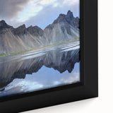 Close-up of a framed canvas wall art piece depicting a vibrant landscape with textured rocks and earthy tones, designed to enhance home decor aesthetics.