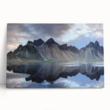 Stretched canvas wall art showcasing a serene landscape with rocky formations, rich earthy tones, and soft blue skies, perfect for enhancing modern home decor.